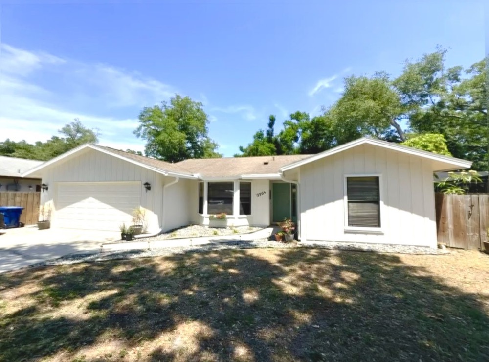 Fresh white exterior paint on a single-story Florida home