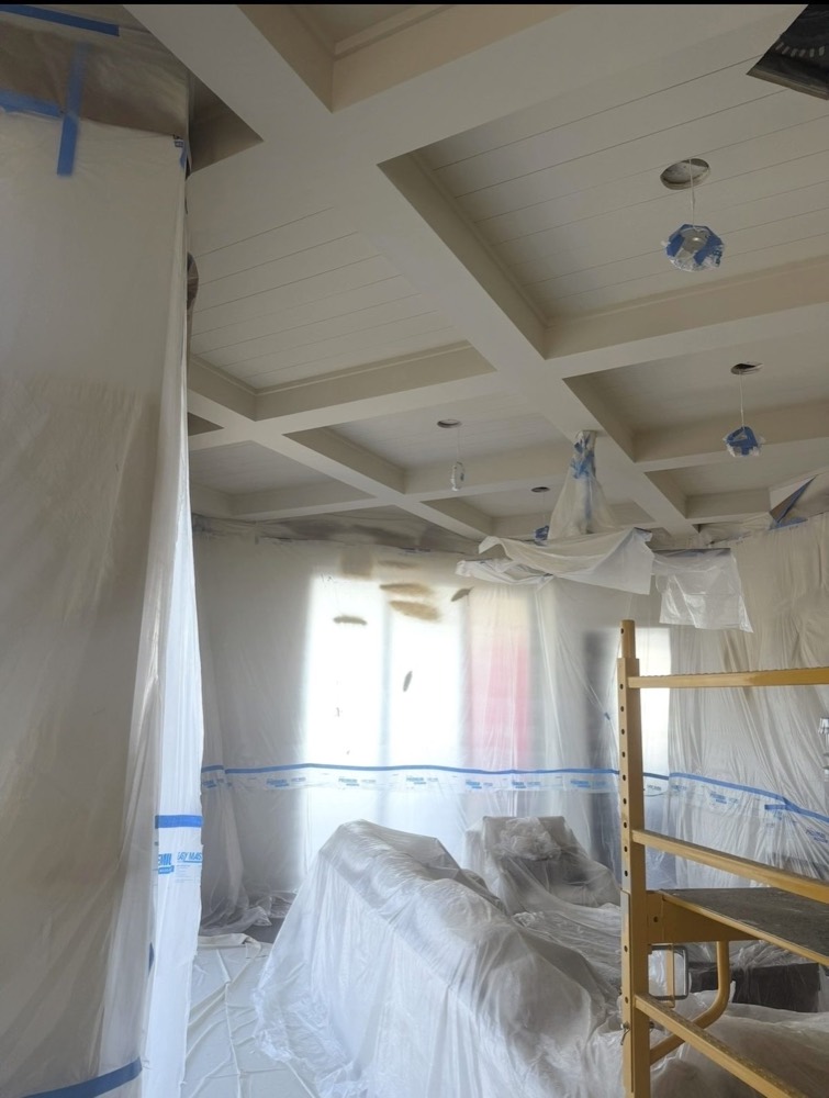 Living room masked and prepped for spray-finishing a coffered ceiling